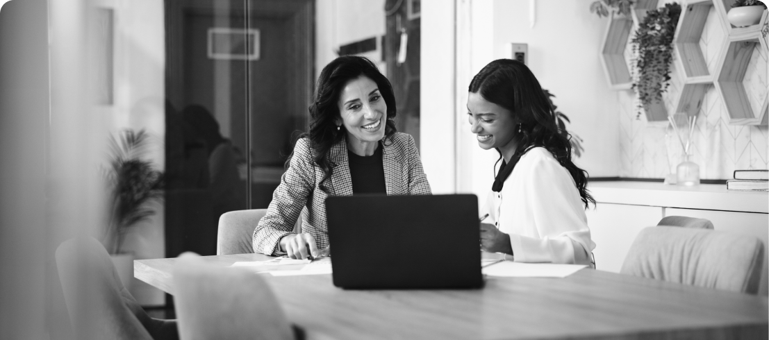 Women discussing work in an office