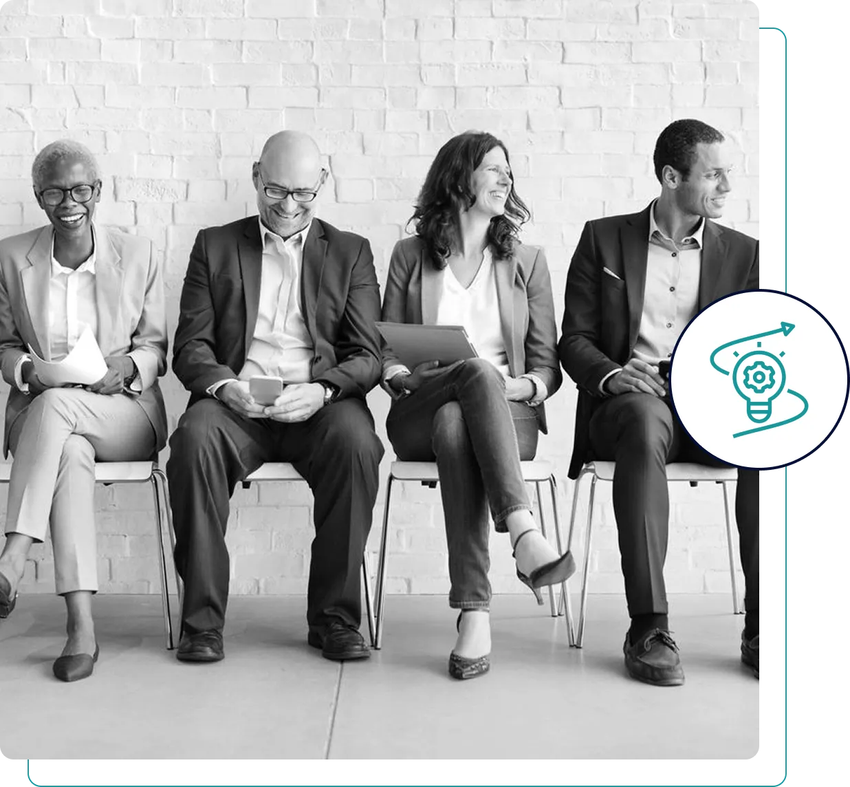 Four diverse professionals seated on a bench, waiting in a modern office setting.