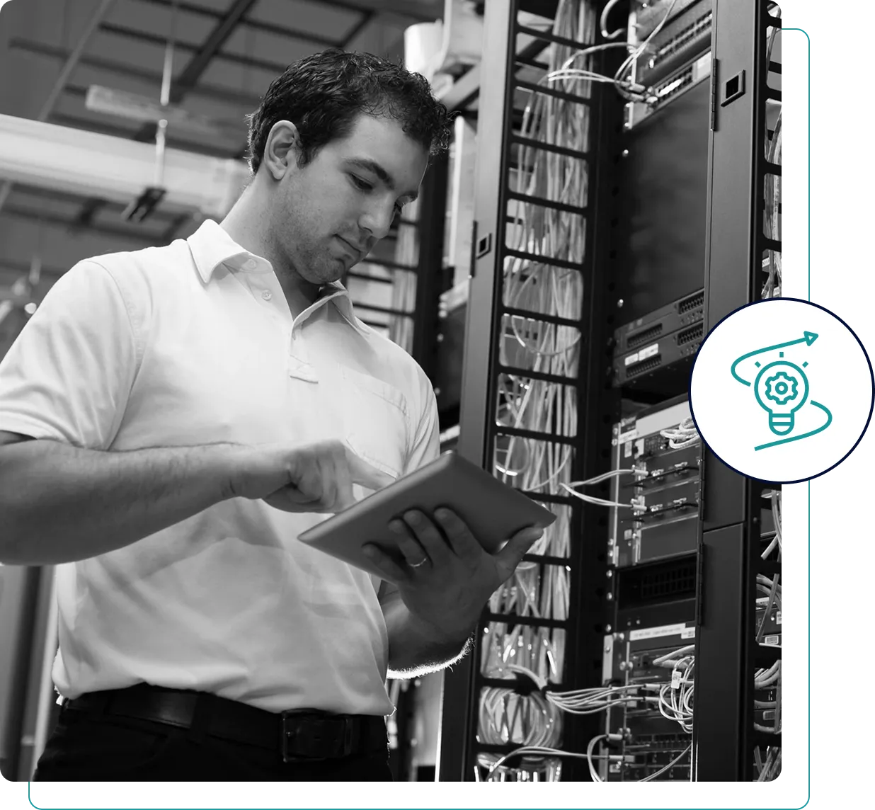Technician managing server racks with a tablet in a data center.