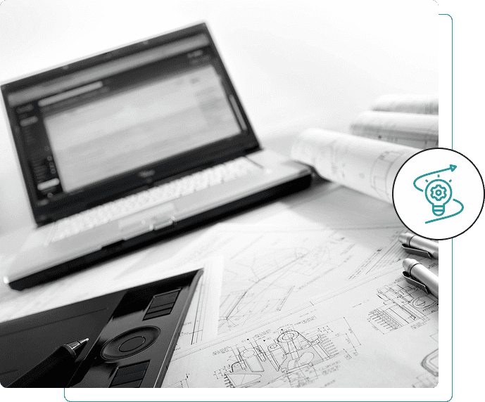 Workspace with laptop, architectural plans, and calculator for design work.