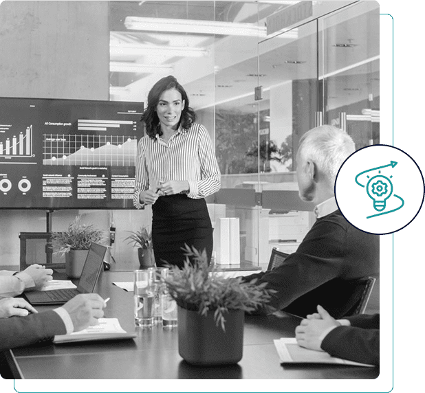 Businesswoman presenting to colleagues in a modern office.
